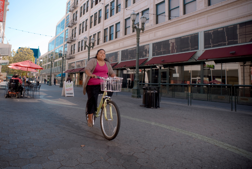 Woman riding a bicycle.