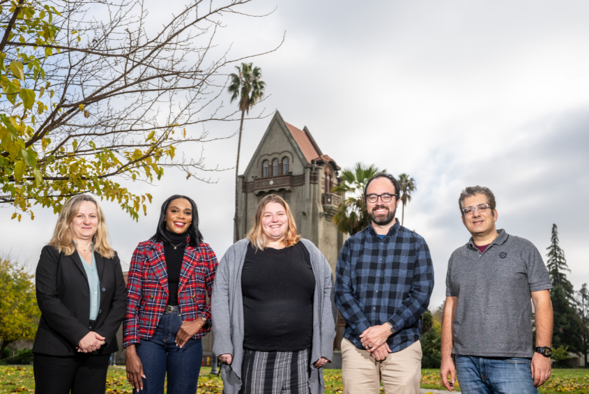 SJSU employees posing for a photo in front of Tower Hall