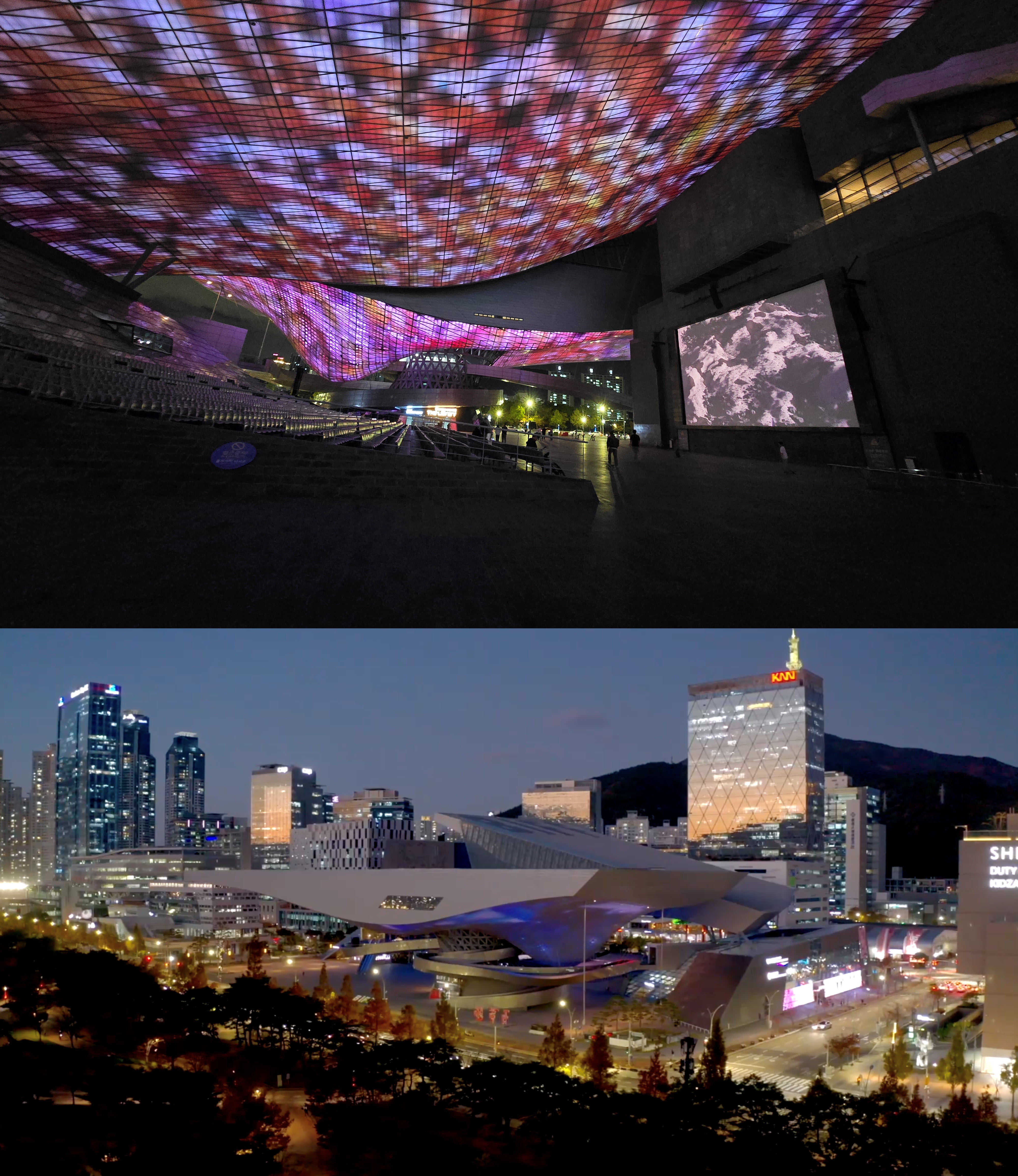 A futuristic architectural space with a large, curved LED ceiling displaying vibrant, abstract visuals in red, purple, and blue hues. The darkened interior has a few people walking, and a large screen on the wall shows a black-and-white image of Earth's surface. Below, a second image shows a cityscape at dusk with a modern, spaceship-like building illuminated in soft blue light, surrounded by high-rise buildings and streetlights. The urban environment is lively, with cars and people visible in the streets.