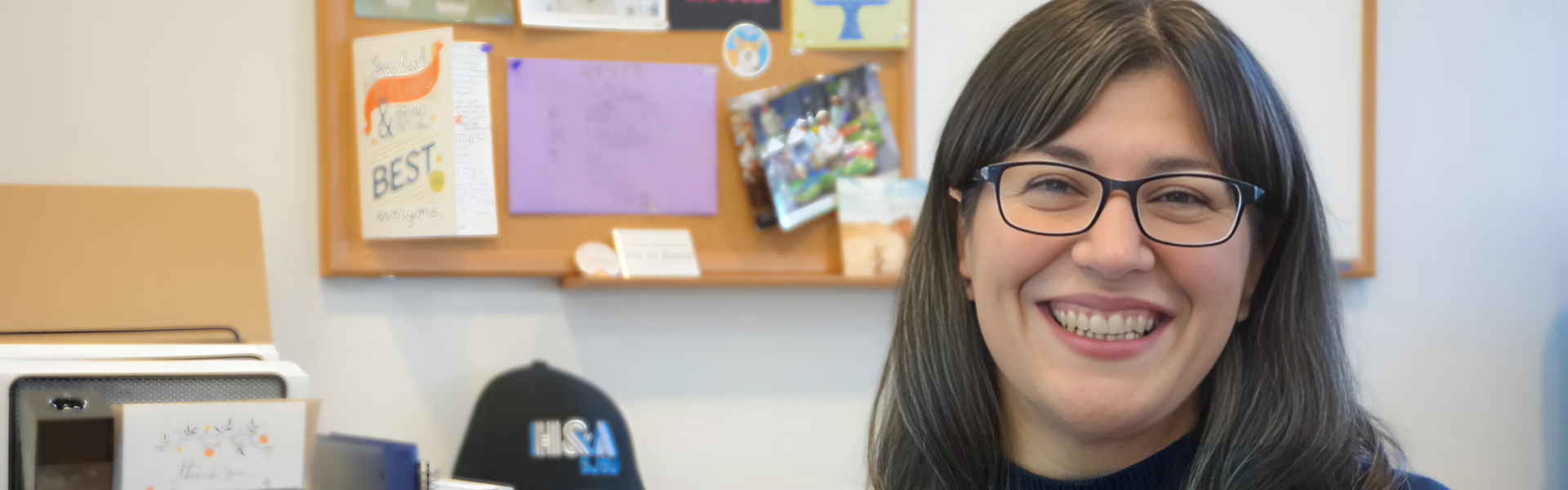 Writing Center director sitting at desk smiling